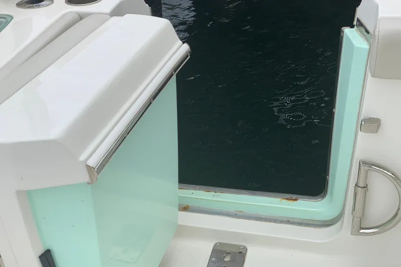 Slide: The Image of 2023 Sailfish 276 DC boat door open, revealing water view. - 20