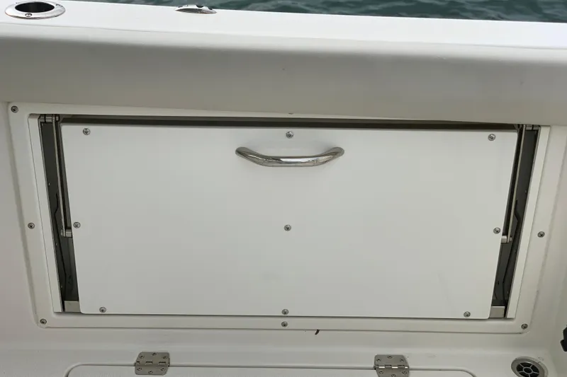 Slide: The Image of Storage compartment on a 2023 Sailfish 276 DC boat, featuring a sleek handle design. - 21