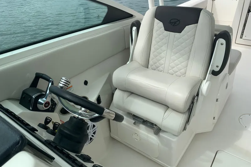 Slide: The Image of Captain's seat and controls on 2023 Sailfish 276 DC boat, featuring luxurious design and ergonomic layout. - 25