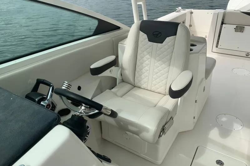 Slide: The Image of Luxury helm seat on 2023 Sailfish 276 DC boat, featuring elegant design and controls. - 26