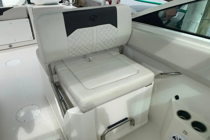 Slide: The Image of 2023 Sailfish 276 DC boat interior with cushioned seating and cup holders. - 27