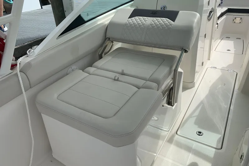 Slide: The Image of 2023 Sailfish 276 DC boat interior with cushioned seating and sleek design. - 30