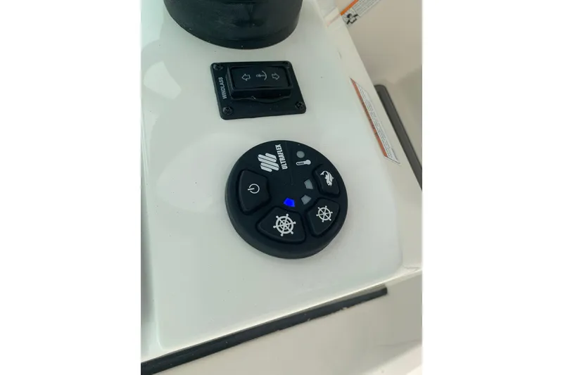 Slide: The Image of Control panel of 2023 Sailfish 276 DC boat with various function buttons. - 35