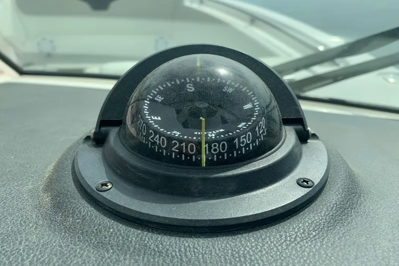 Slide: The Image of Compass on 2023 Sailfish 276 DC boat dashboard, showing navigation directions. - 37
