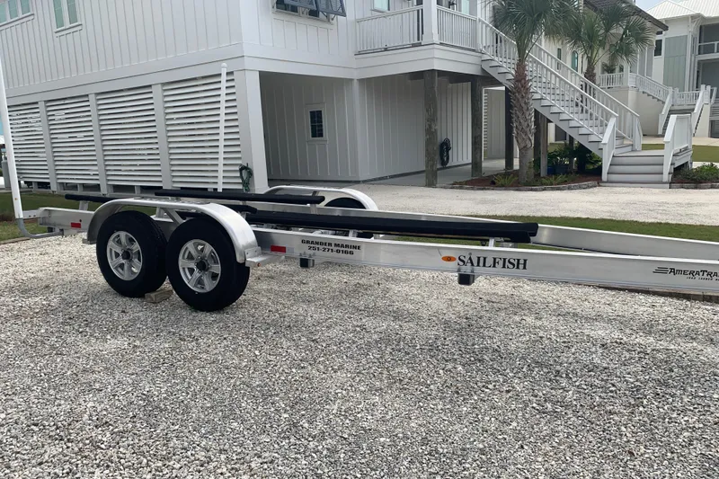 Slide: The Image of Trailer for 2023 Sailfish 276 DC boat parked on gravel driveway. - 38