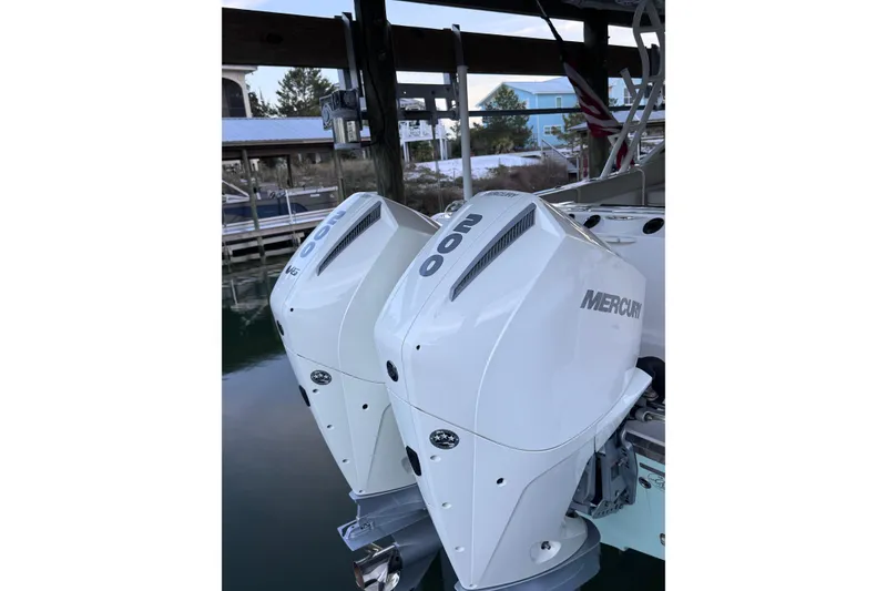Slide: The Image of Twin Mercury outboard engines on a 2023 Sailfish 276 DC boat at a dock. - 4