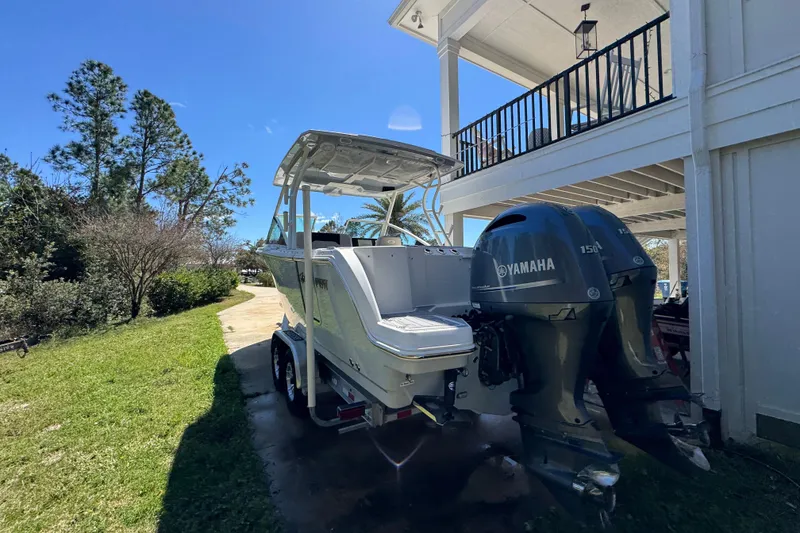 Slide: The Image of 2022 Sailfish 276 DC boat with Yamaha engines parked outdoors. - 14