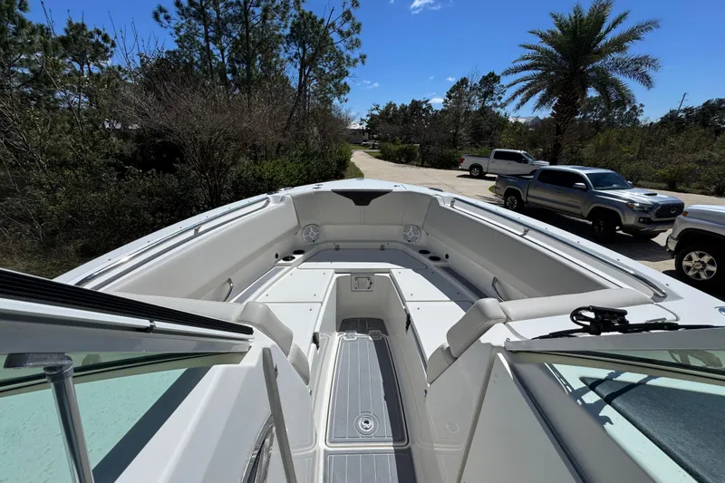 Slide: The Image of 2022 Sailfish 276 DC boat interior with seating and open deck view. - 16