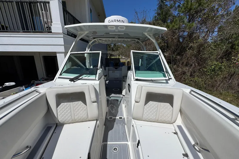 Slide: The Image of 2022 Sailfish 276 DC boat interior with Garmin equipment, featuring spacious seating and modern design. - 19