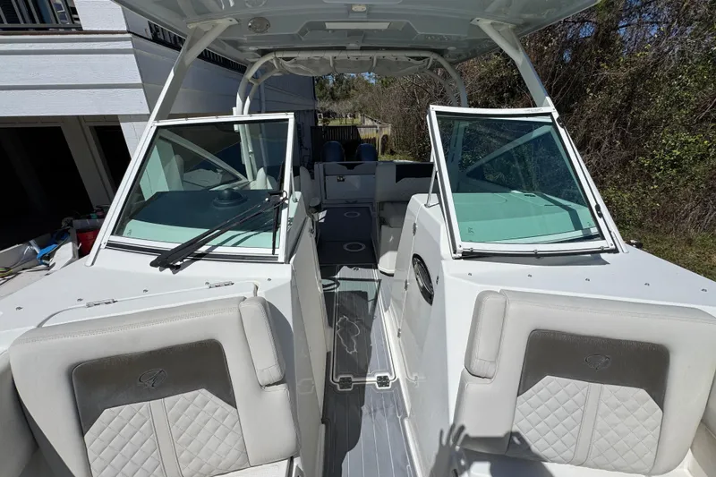 Slide: The Image of 2022 Sailfish 276 DC boat interior with dual consoles and cushioned seating. - 20