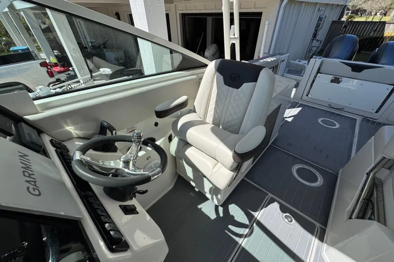Slide: The Image of 2022 Sailfish 276 DC boat interior with steering wheel and captain's chair. - 21