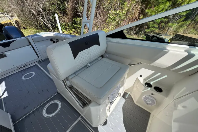 Slide: The Image of 2022 Sailfish 276 DC boat interior with cushioned seating and modern design. - 25