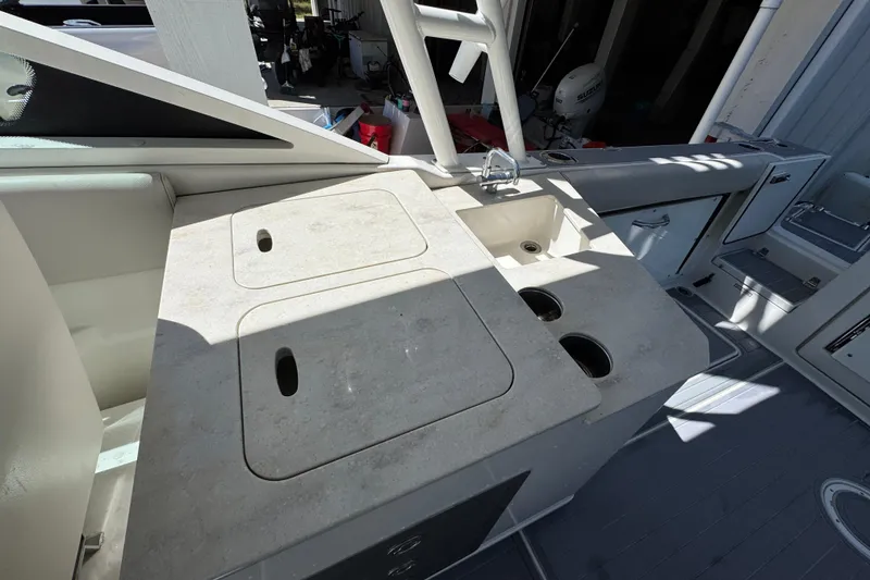 Slide: The Image of 2022 Sailfish 276 DC boat interior with sink and storage compartments. - 27