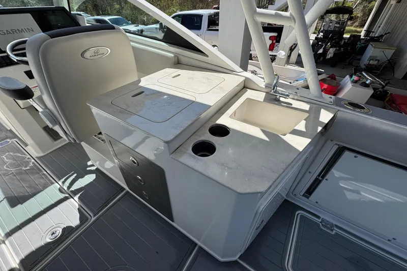 Slide: The Image of 2022 Sailfish 276 DC boat interior with sink and storage compartments. - 28