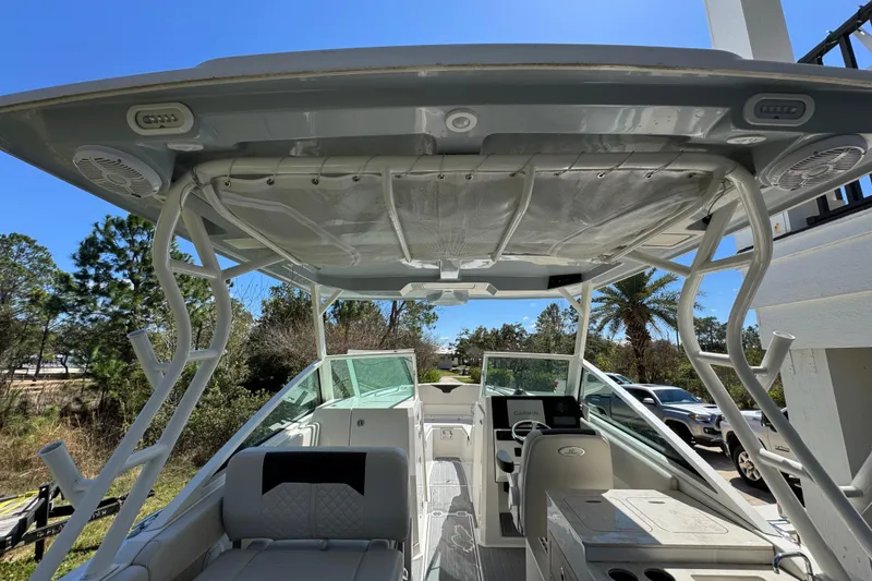 Slide: The Image of 2022 Sailfish 276 DC boat interior with seating and navigation equipment under a clear sky. - 30