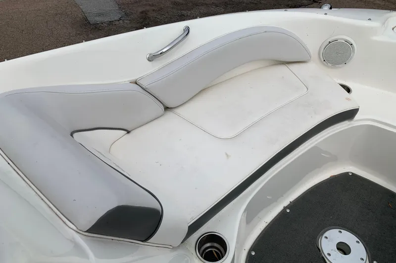 Slide: The Image of 2012 Sea Ray 200 Sundeck boat interior with white cushioned seating and speaker. - 11