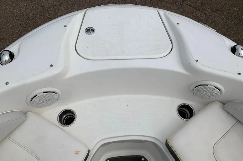 Slide: The Image of Bow seating area of a 2012 Sea Ray 200 Sundeck boat with speakers and storage. - 12
