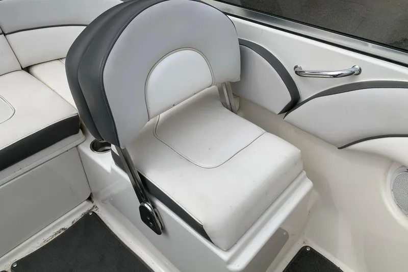 Slide: The Image of 2012 Sea Ray 200 Sundeck interior with white and gray seating. - 15