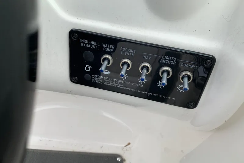 Slide: The Image of Control panel of a 2012 Sea Ray 200 Sundeck boat with labeled switches. - 19