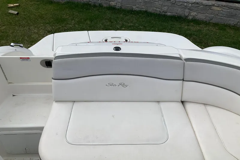 Slide: The Image of 2012 Sea Ray 200 Sundeck boat interior with white seating and logo. - 20