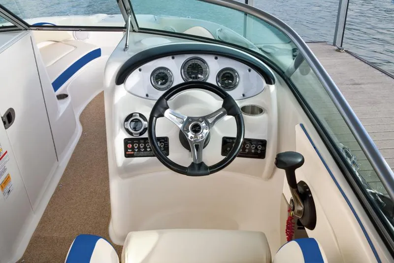 Slide: The Image of Manufacturer Provided Image: 2012 Sea Ray 200 Sundeck boat cockpit with steering wheel and control panel. - 3