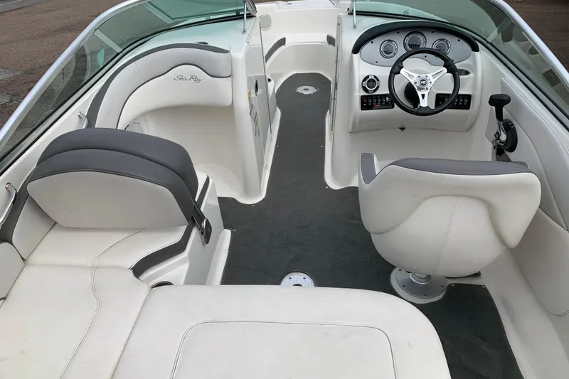 Slide: The Image of Interior of a 2012 Sea Ray 200 Sundeck boat with steering wheel and seating. - 6
