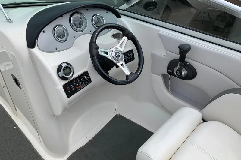 Slide: The Image of 2012 Sea Ray 200 Sundeck boat dashboard with steering wheel and controls. - 7
