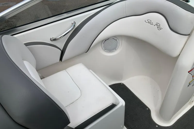 Slide: The Image of Interior seating of 2012 Sea Ray 200 Sundeck boat, featuring white and gray upholstery. - 8