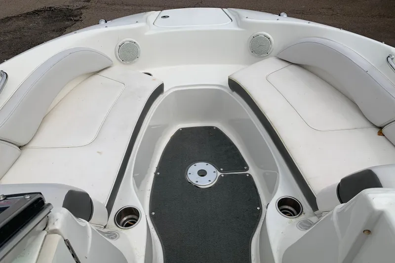 Slide: The Image of 2012 Sea Ray 200 Sundeck interior with white seating and gray flooring. - 9