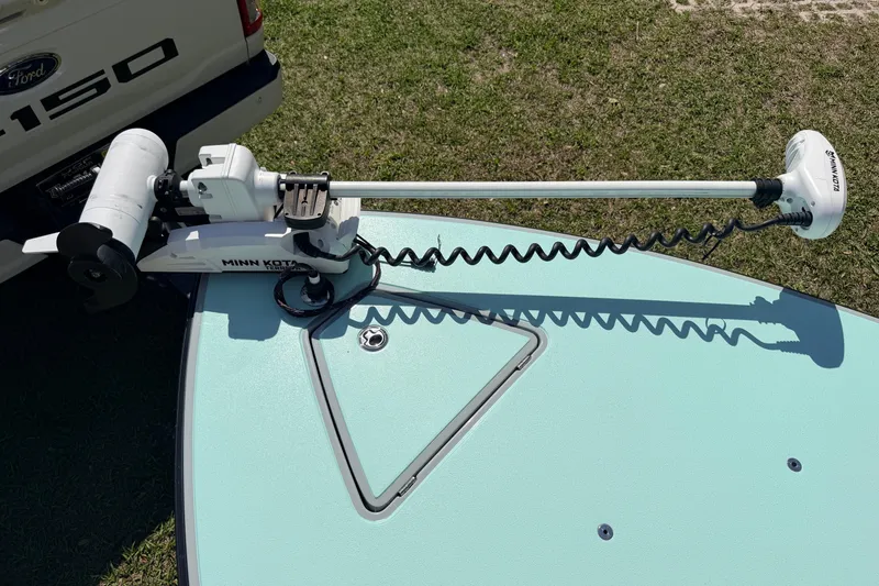 Slide: The Image of Minn Kota trolling motor on 2022 Chittum Skiffs Islamorada 21, parked near Ford F-150. - 10