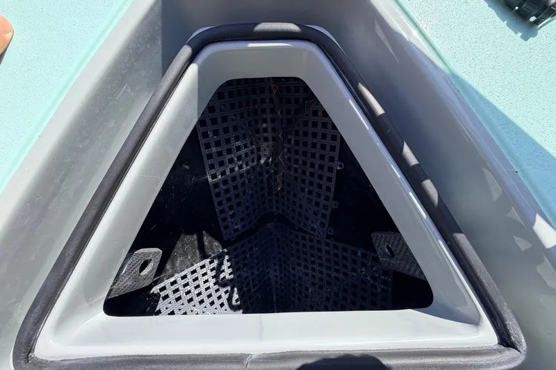 Slide: The Image of Storage compartment of 2022 Chittum Skiffs Islamorada 21 boat, featuring a triangular design. - 13