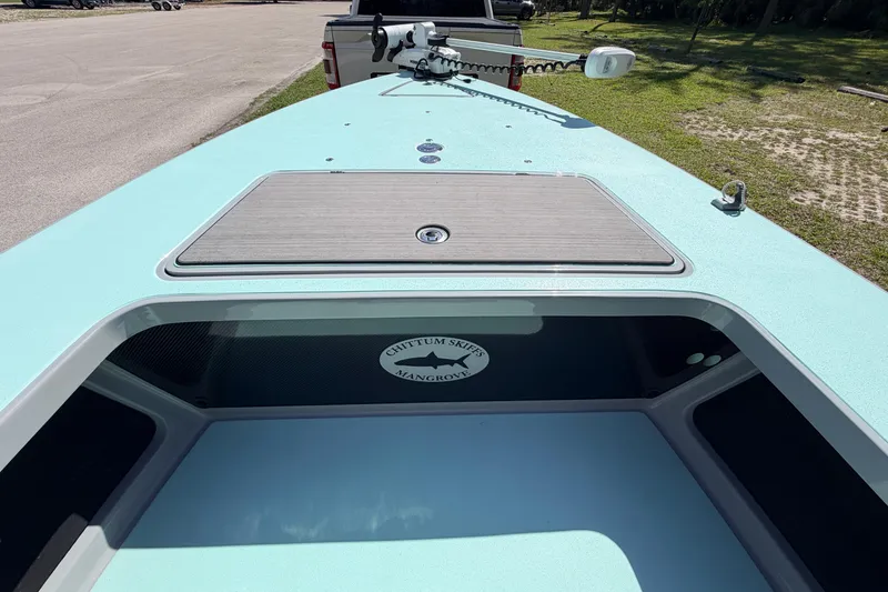 Slide: The Image of 2022 Chittum Skiffs Islamorada 21 boat deck with storage compartment and logo. - 15