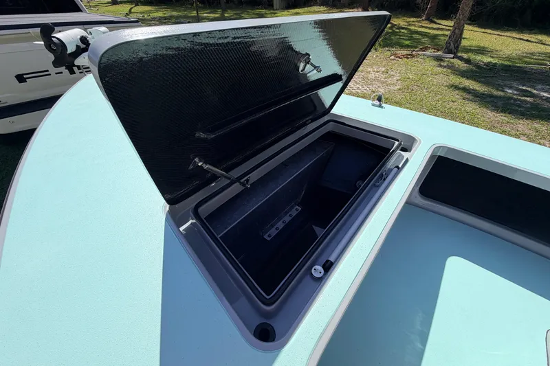 Slide: The Image of Open storage compartment on 2022 Chittum Skiffs Islamorada 21 boat, showcasing interior space. - 16