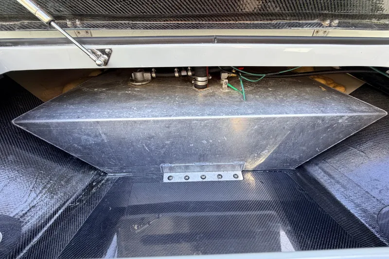 Slide: The Image of 2022 Chittum Skiffs Islamorada 21 fuel tank compartment with metal tank and wiring. - 17