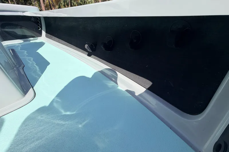 Slide: The Image of Interior view of 2022 Chittum Skiffs Islamorada 21 boat, featuring sleek design and light blue flooring. - 22