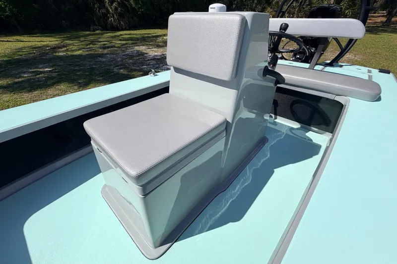 Slide: The Image of 2022 Chittum Skiffs Islamorada 21 boat interior with cushioned seating and steering console. - 24