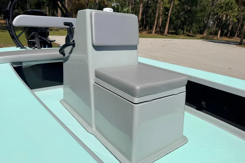 Slide: The Image of 2022 Chittum Skiffs Islamorada 21 boat seat and console, featuring sleek design and light gray upholstery. - 25