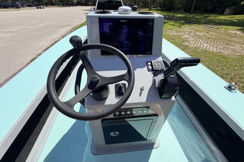 Slide: The Image of 2022 Chittum Skiffs Islamorada 21 boat console with steering wheel and controls. - 26