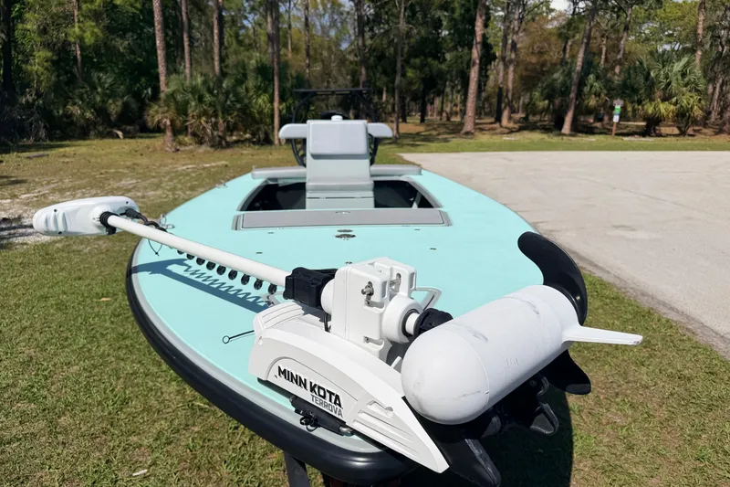 Slide: The Image of 2022 Chittum Skiffs Islamorada 21 with Minn Kota Terrova motor in a wooded area. - 3