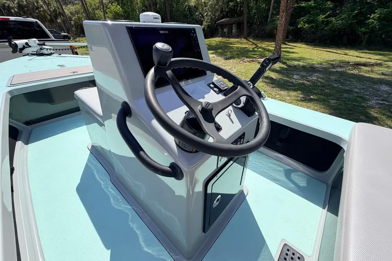 Slide: The Image of 2022 Chittum Skiffs Islamorada 21 boat console with steering wheel and controls. - 32