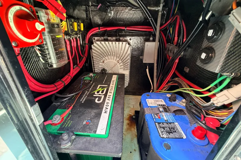 Slide: The Image of Electrical system inside 2022 Chittum Skiffs Islamorada 21, featuring batteries and wiring. - 34