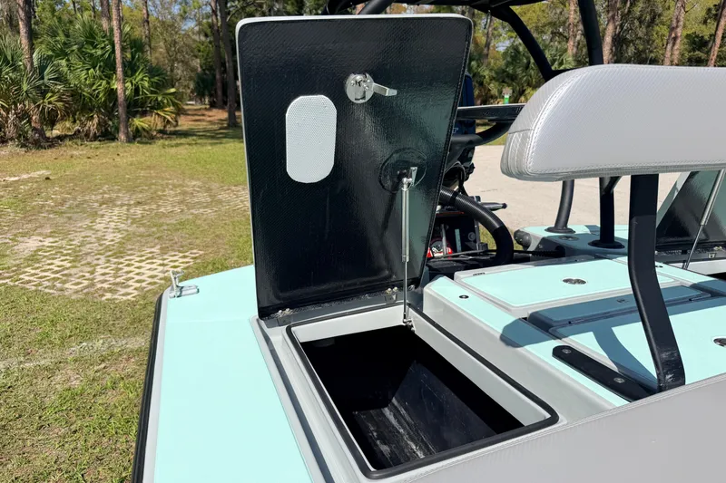 Slide: The Image of 2022 Chittum Skiffs Islamorada 21 boat storage compartment open, showcasing interior details. - 39