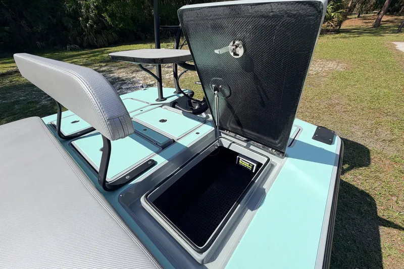 Slide: The Image of 2022 Chittum Skiffs Islamorada 21 boat with open storage compartment and seating. - 46