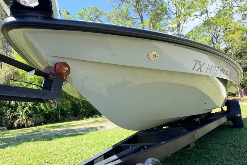 Slide: The Image of 2022 Chittum Skiffs Islamorada 21 boat on trailer, side view in a grassy area. - 5