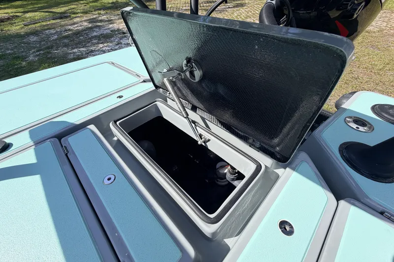 Slide: The Image of 2022 Chittum Skiffs Islamorada 21 boat storage compartment open, showcasing interior features. - 52