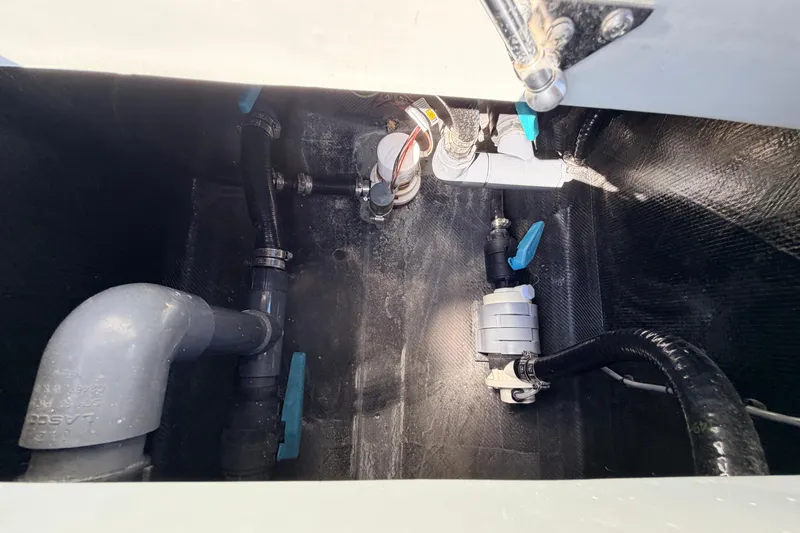 Slide: The Image of Bilge area of 2022 Chittum Skiffs Islamorada 21 with plumbing components. - 53