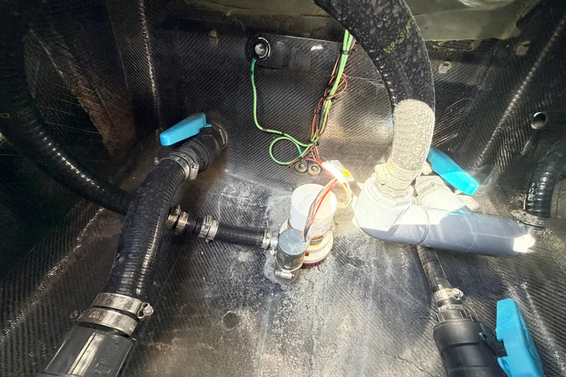 Slide: The Image of 2022 Chittum Skiffs Islamorada 21 bilge area with hoses and wiring. - 54