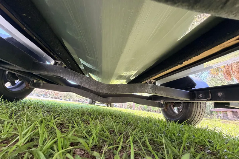 Slide: The Image of Underside view of 2022 Chittum Skiffs Islamorada 21 on trailer, grassy background. - 75