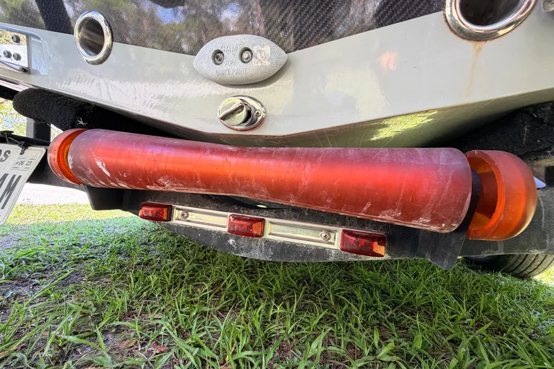 Slide: The Image of Rear view of 2022 Chittum Skiffs Islamorada 21 boat on grass, showing exhaust and trailer lights. - 76