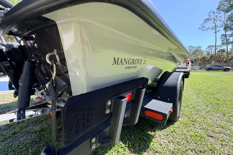 Slide: The Image of 2022 Chittum Skiffs Islamorada 21 boat on trailer, grassy background. - 78